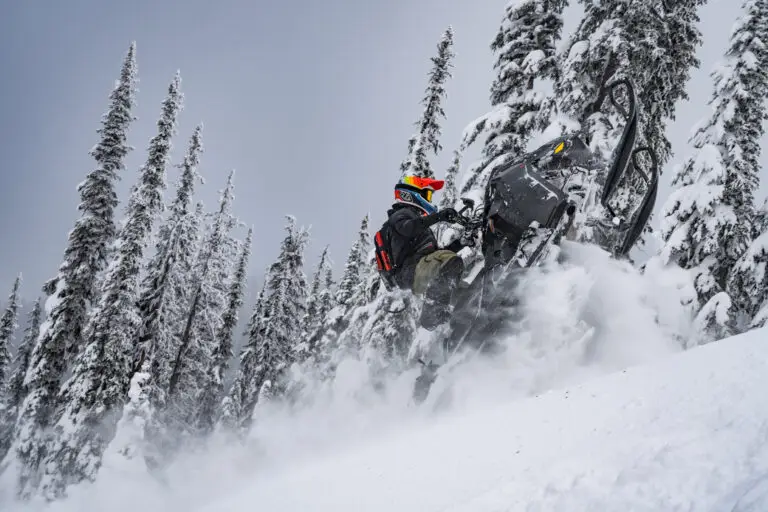 Snowmobile tour climbing hill